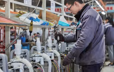 About Employee working with components at a manufacturing workstation